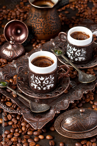 Hot coffee in Turkish copper pot, traditional mugs and coffee beens © amberto4ka