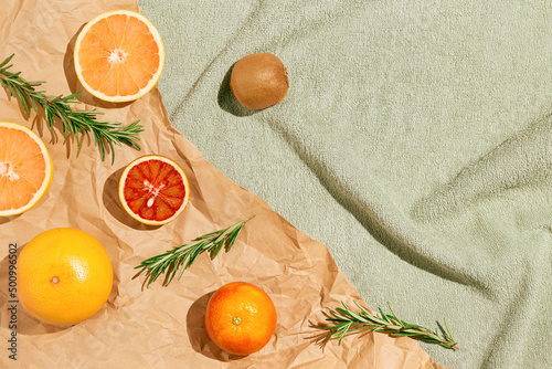 Wallpaper Mural Creative summer scene with fruits,rosemary on craft paper and pastel green beach towel. Refreshment concept. Sunlit flat lay. Healthy food background. Minimal style. Top view. Torontodigital.ca
