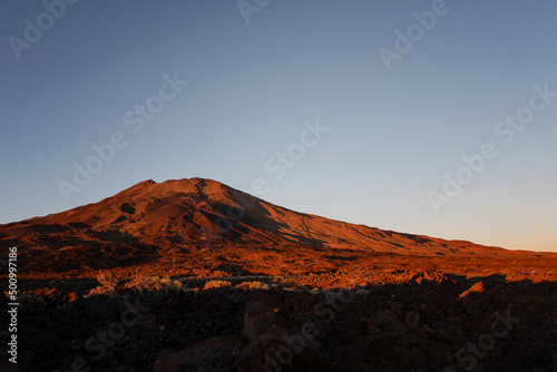 Sunset and scenic view of Mount Teide, a volcano on Tenerife in the Canary Islands, Spain. Beautiful golden hour light on the volcanic landscape and mountain.
