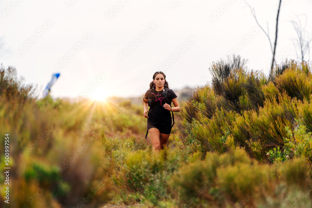 latin young woman doing trail running