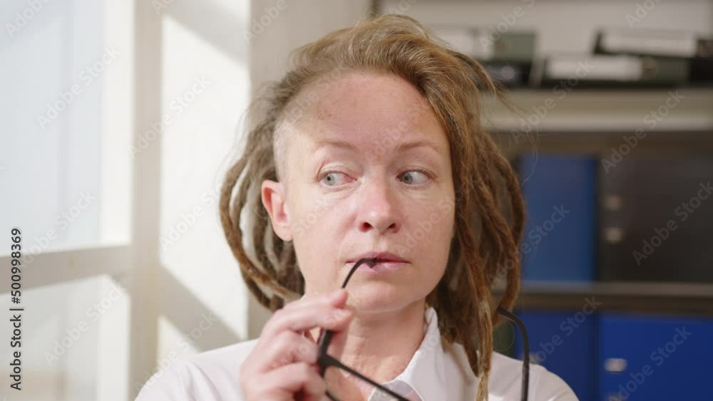 Portrait of thinking business woman in office near window, ideas occurring suddenly in mind. Portrait of thinking business woman in office near window, ideas occurring suddenly in mind.