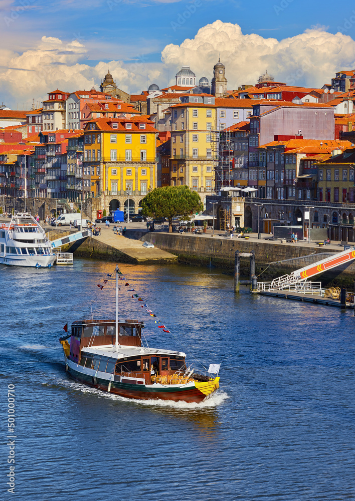 Porto Portugal. Pleasure boat at river Douro. View at old town with authentic house. Picturesque landscape vintage Europe.