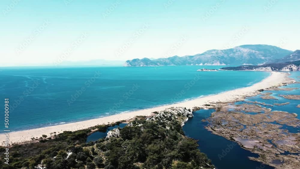 Aerial Survay Over the River Dalyan. Iztuzu Sand Spit Separates the River and the Sea. Tourist Boat Sailing on the River. Birds Eye View 4k