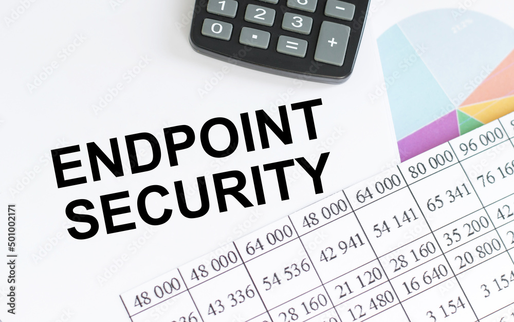 Text ENDPOINT SECURITY on a notepad on a table next to a calculator and financial reports, a business concept Text ENDPOINT SECURITY on a notepad on a table next to a calculator and financial reports, a business concept