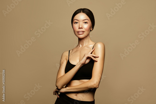 Asian young woman with long ponitail hair portrait. Thin fit body shape. Hair care concept