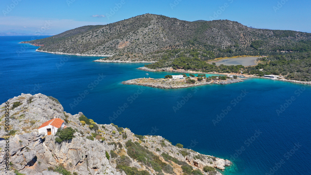 Aerial drone photo of small island of Dorousa and small chapel of Profitis Ilias built uphill next to famous Aponisos bay, Agistri island, Greece