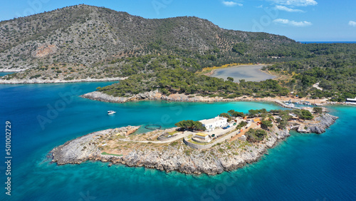 Aerial drone photo of iconic Aponisos bay and lake with clear turquoise sea and pine trees, Agistri island, Saronic gulf, Greece