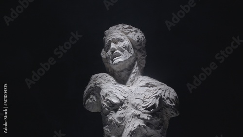 A white statue of a man. A close-up shot on a black background. © stanis88