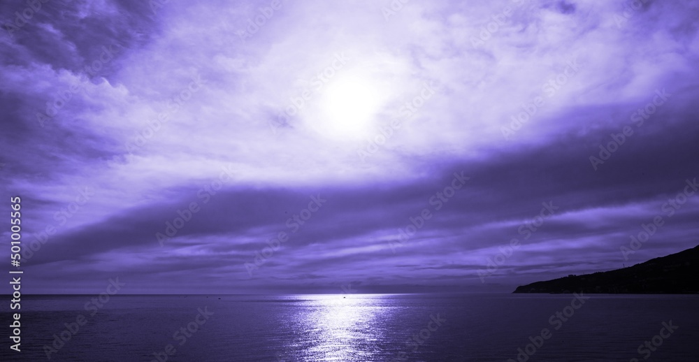 Violet purple evening over. Sea mount Impressive sunset over the lake.