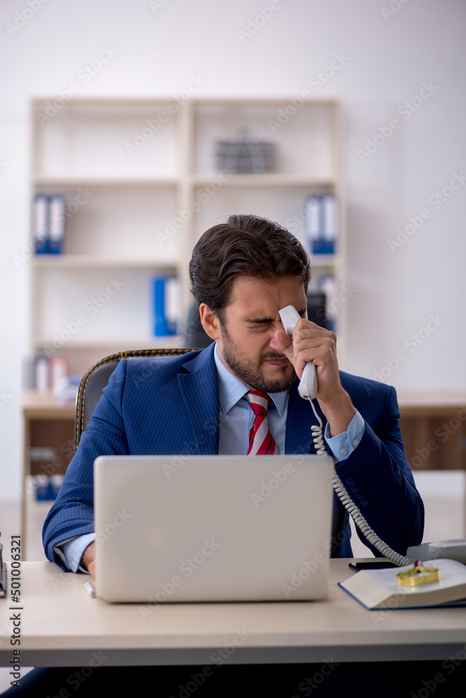 Young male employee working in the office Young male employee working in the office