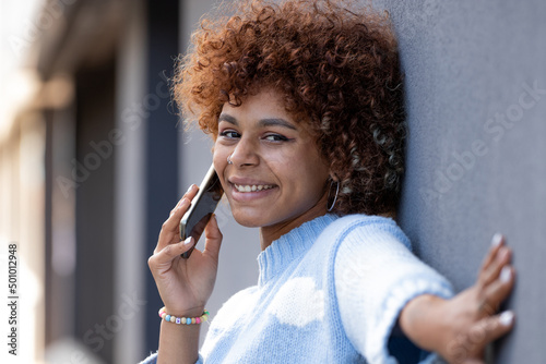 african american girl talking on the phone in the street