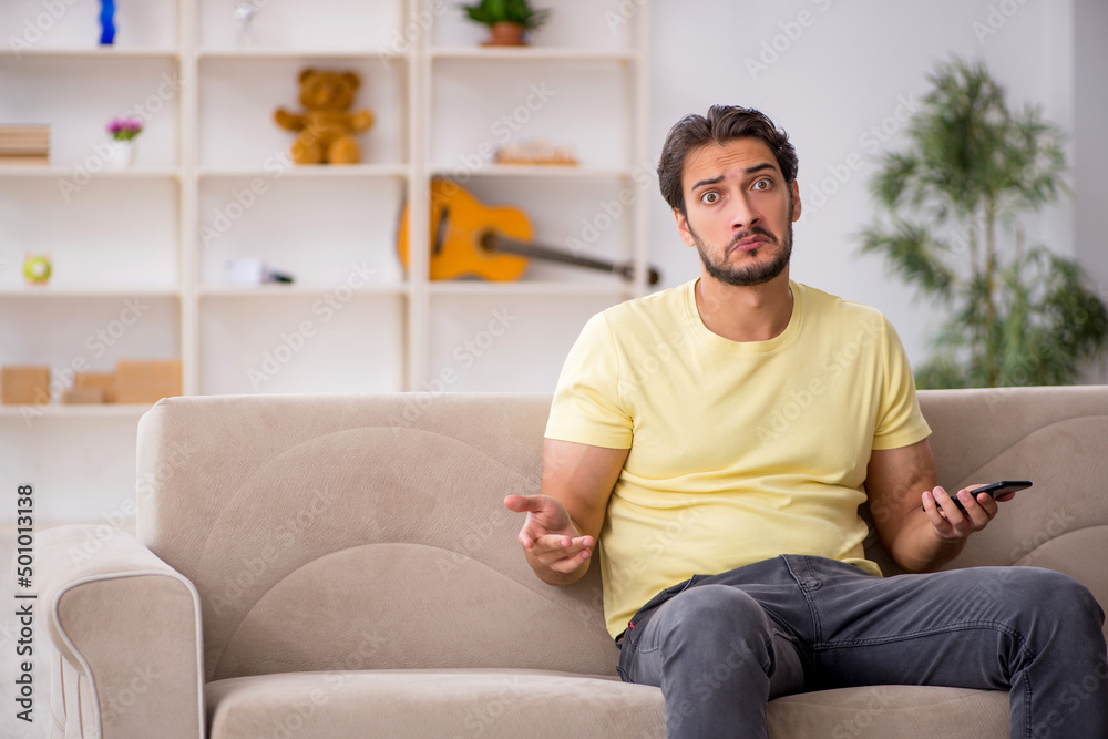 Young man sitting at home during pandemic