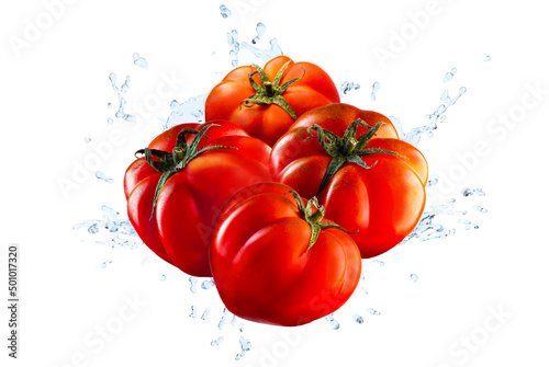 Water splashing on fresh pachino red tomatoes over white background.