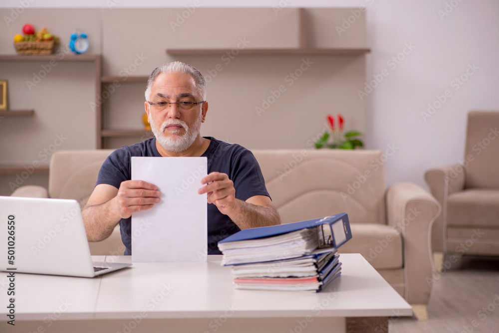 Old male employee working from home during pandemic Old male employee working from home during pandemic