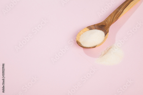 Collagen powder on pink background.