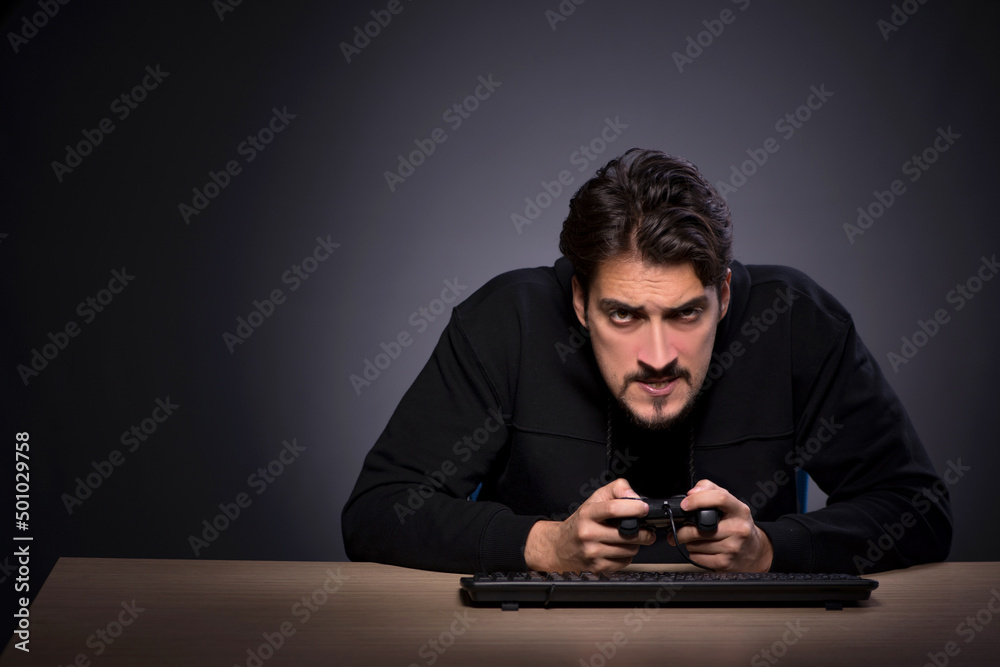 Young male gamer on grey background Young male gamer on grey background