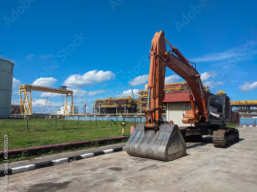 Malaysia, 23 April 2022: Hitachi orange escavator located in the factory area. photo