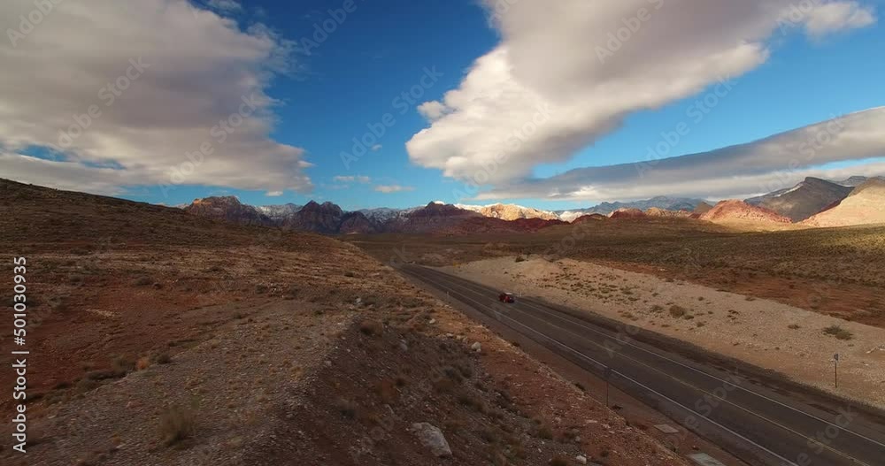 Aerial Forward Beautiful Shot Of Car Moving On Road In Semi Arid Desert - Las Vegas, Nevada Aerial Forward Beautiful Shot Of Car Moving On Road In Semi Arid Desert - Las Vegas, Nevada