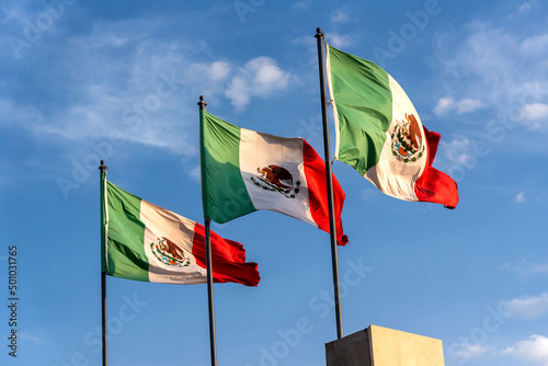 Three mexican flags waving - blue sky  photo