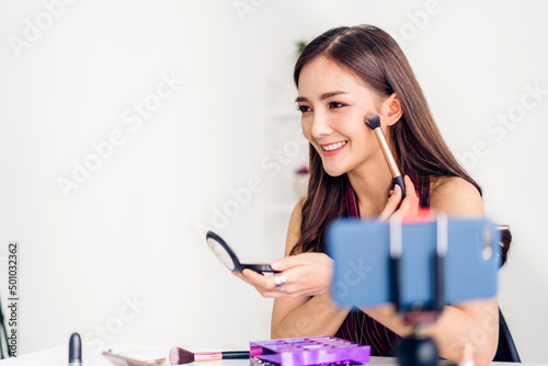 Smiling of pretty woman beauty clean fresh healthy white skin blogger in front of camera recording video content for live stream chat talking with makeup cosmetic for internet social network at home
