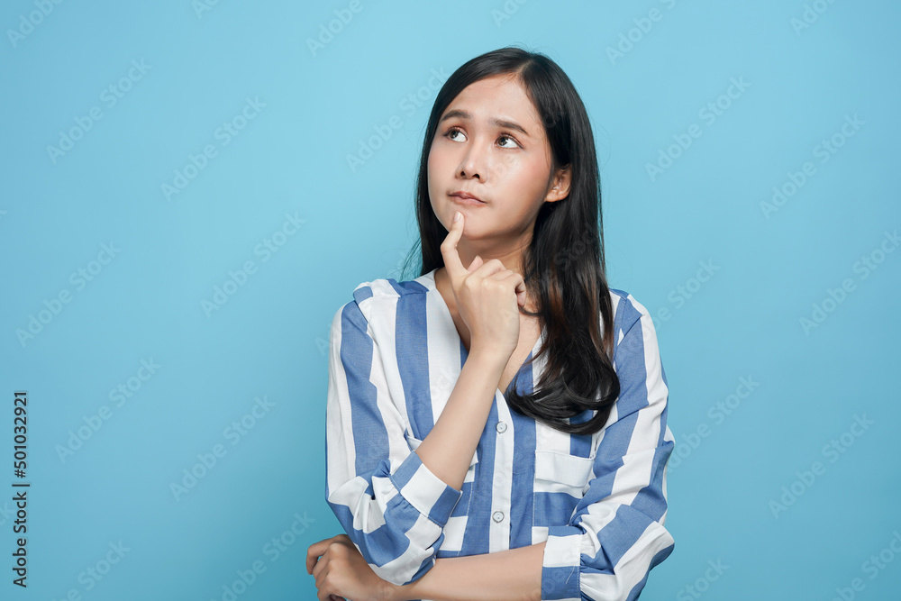 young asian woman look up considering think and doubt why young asian woman look up considering think and doubt why