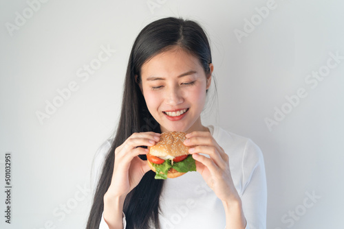 Asian woman smiling when eat fastfood isolated on whit background.