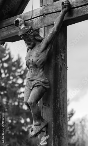 an old sculpture of Jesus crucified on the cross in the Pecs cemetery - Hungary