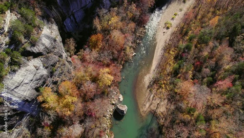 Aerial Forward Beautiful View Of River Flowing In Forest During Autumn Season - Jasper, Arkansas photo