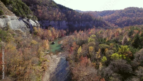 Aerial Forward Scenic Shot Of River Amidst Autumn Trees In Forest - Jasper, Arkansas photo