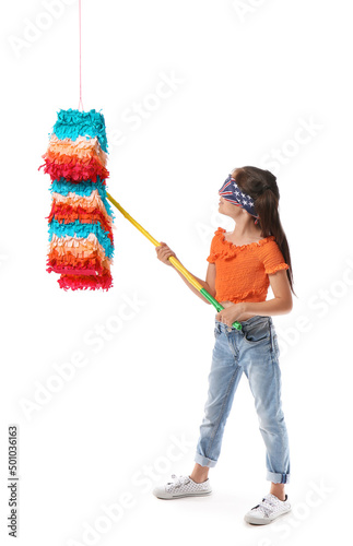 Little girl breaking Mexican pinata on white background