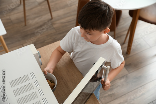 Little boy heating food in ...
