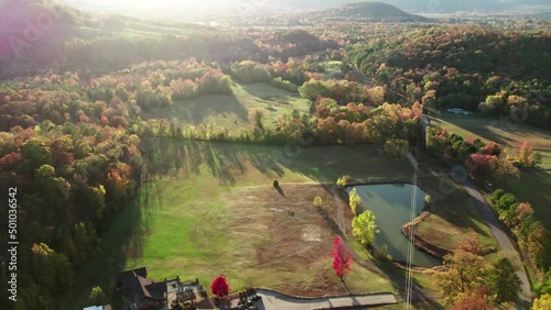 Aerial Forward Beautiful View Of Houses In Forest During Autumn Season - Russellville, Arkansas photo