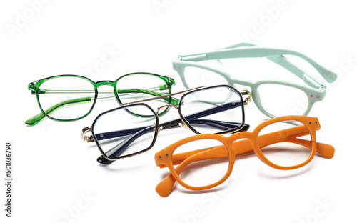 Different plastic eyeglasses on white background