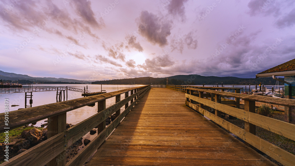 Wooden public pier early on a cloudy Spring morning at a Sooke, BC, marina on Juan de Fuca Straits.