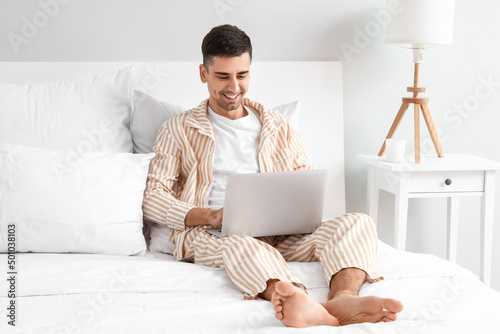 Young barefooted man using ...