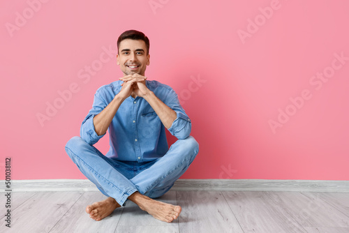 Young barefooted man sittin...