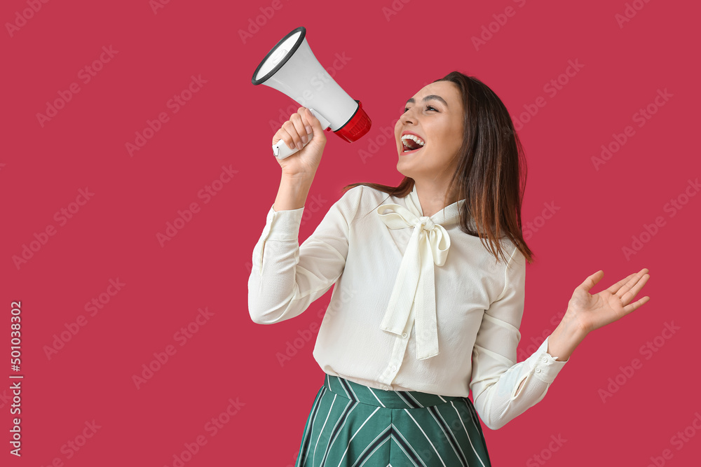 Emotional young woman with megaphone on color background Emotional young woman with megaphone on color background
