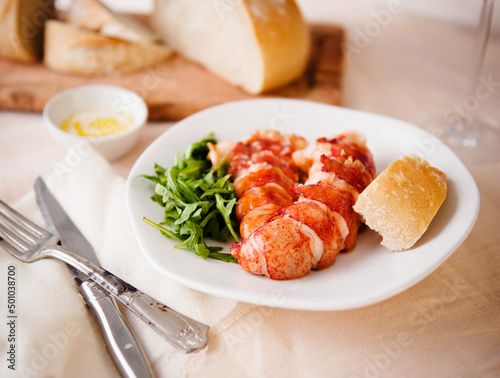 Lobster tails with bread, butter and greens photo