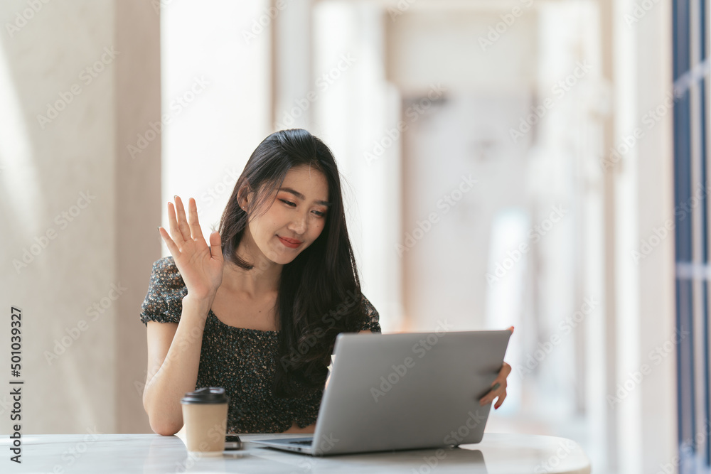 Portrait of Asian young female working on laptop and financial report at coffee shop. Portrait of Asian young female working on laptop and financial report at coffee shop.