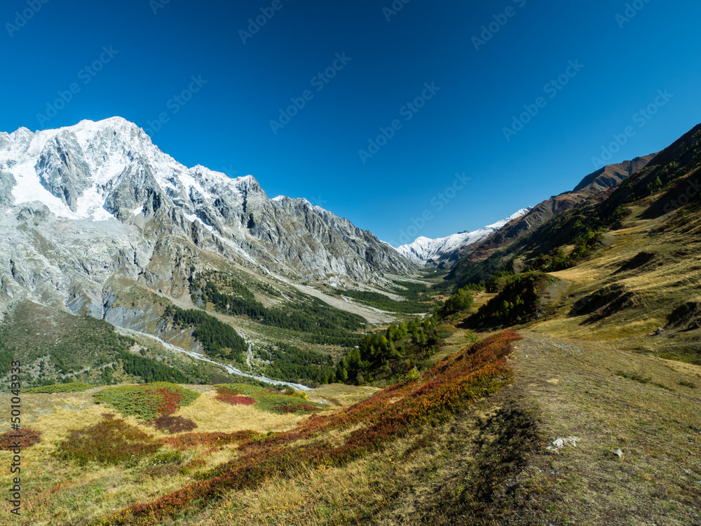 Panoramic view of valley Valle d'Aosta with beautiful mountains landscape in the background and blue sky above. Autumn in the Pennine Alps, Valle d'Ao