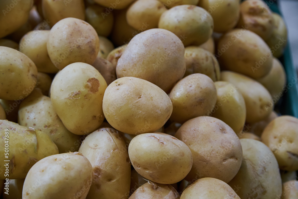 Organic potatoes put on a shelf for sale within a market Organic potatoes put on a shelf for sale within a market