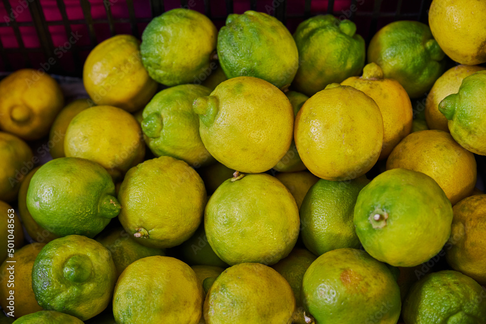 Limes placed on a shelf for sale in a market