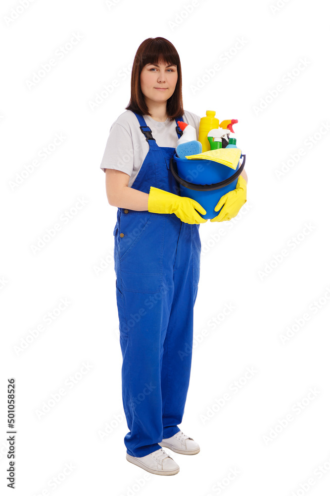 housework and cleaning concept - full length portrait of young female cleaner in blue uniform and yellow gloves holding bucket with cleaning equipment isolated on white background housework and cleaning concept - full length portrait of young female cleaner in blue uniform and yellow gloves holding bucket with cleaning equipment isolated on white background