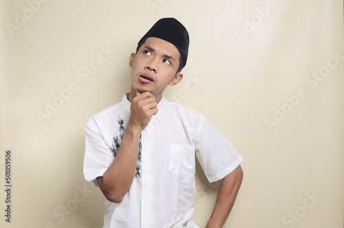 Asian muslim man shows thinking contemplating expression