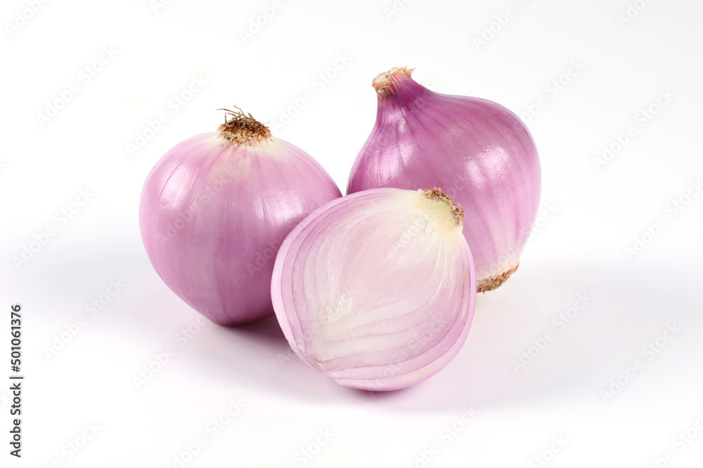 Fototapeta premium Red onion, peeled, halved, placed close-up on a white background It is a vegetable that can be eaten raw.