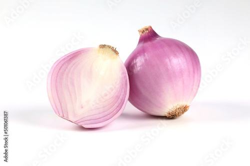 Red onion, peeled, halved, close-up placed on a white background