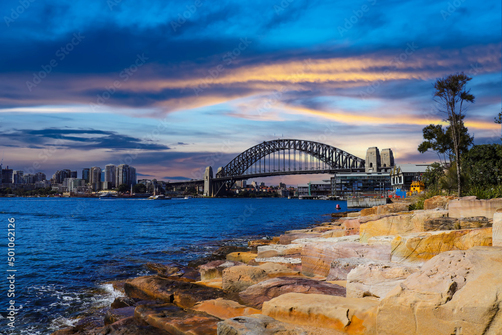 Obraz premium Sydney Harbour Australia with nice colours in the sky. Nice blue water of the Harbour, high rise offices and residential buildings of the City in the background, NSW Australia