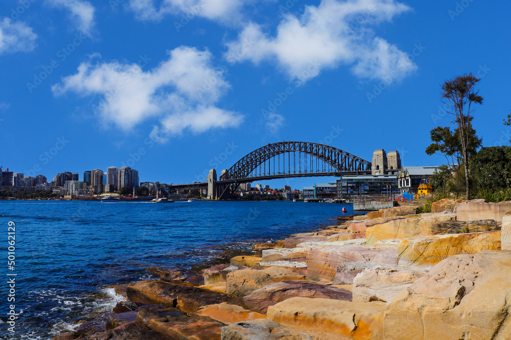 Fototapeta premium Sydney Harbour Australia with nice colours in the sky. Nice blue water of the Harbour, high rise offices and residential buildings of the City in the background, NSW Australia