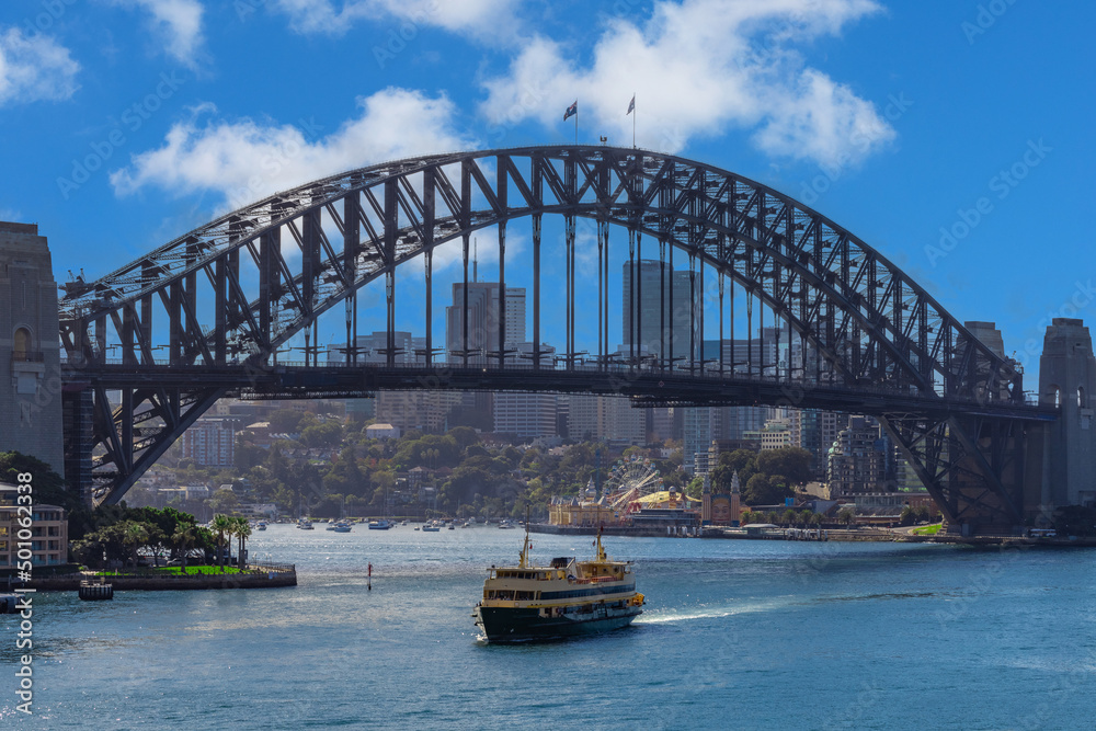 Obraz premium Sydney Harbour Australia with nice colours in the sky. Nice blue water of the Harbour, high rise offices and residential buildings of the City in the background, NSW Australia