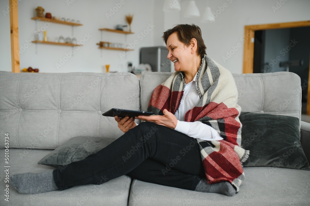 pretty senior woman using tablet computer at home pretty senior woman using tablet computer at home